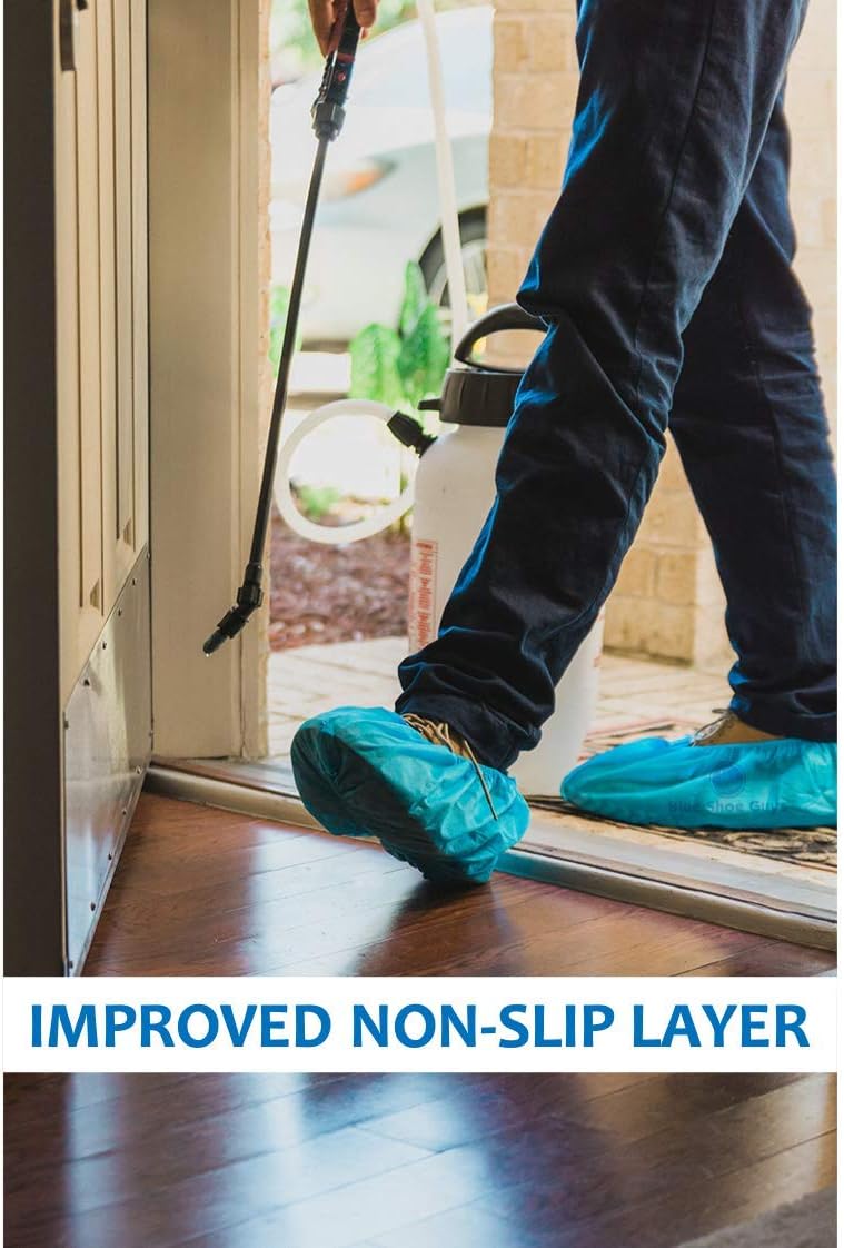 Worker wearing blue shoe covers at a doorway