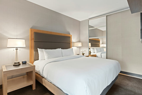 Hotel room bed with crisp white linen