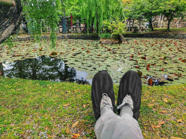 Black disposable shoe covers in use