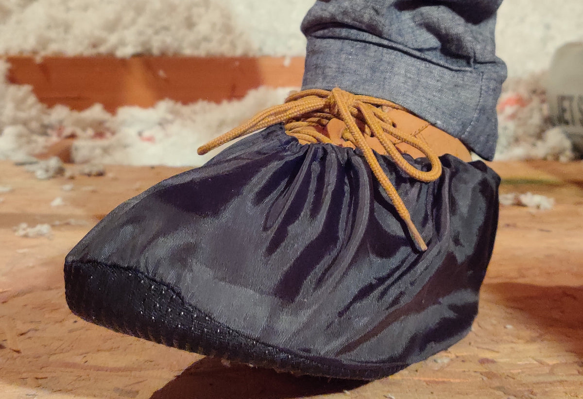 Black reusable shoe cover over a work boot